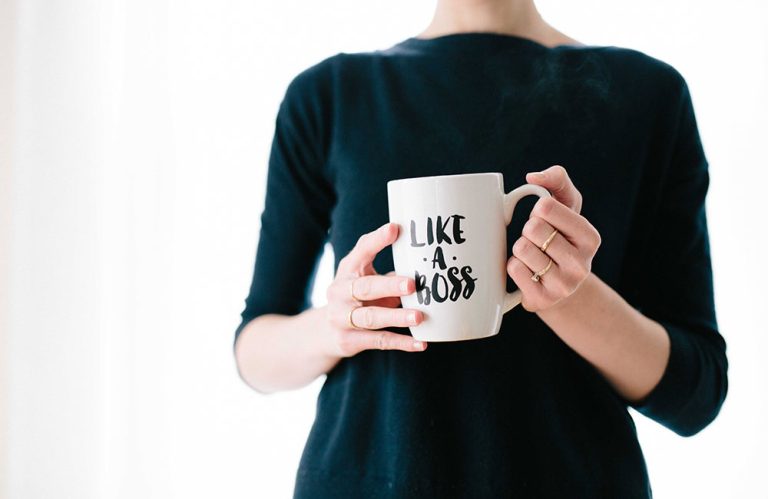 Female financial entrepreneur holding a "like a boss" coffee mug