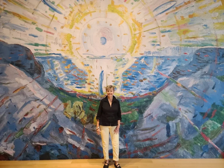 Sally Helgesen standing in front of a giant mural